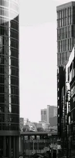 Black and white wallpaper of city skyscrapers.