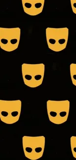 Patterned wallpaper featuring yellow masks on a black background.