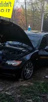 Black car with open hood in outdoor setting, DIY repair scene.