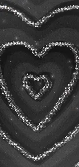 Black wallpaper with glitter hearts design.