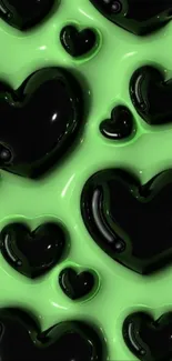 Glossy black hearts on green background wallpaper.