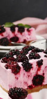 Pink cheesecake with blackberries on top.