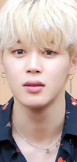 Blonde haired portrait with earrings, dark shirt, and stylish look.