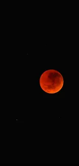 Blood moon on a dark, starry background wallpaper.