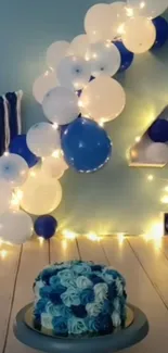 Blue and white themed birthday setup with balloons and cake.