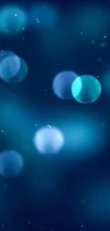 Blue bokeh lights wallpaper with soft orbs on a dark background.