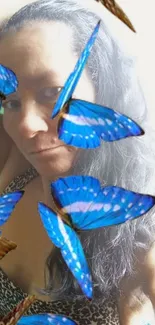 Blue butterflies overlaying a woman's portrait, creating a unique wallpaper.