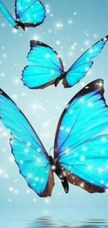 Three vibrant blue butterflies with sparkling accents on a sky blue background.