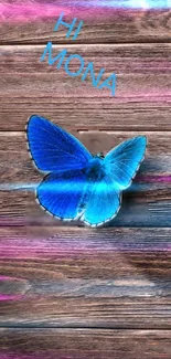 Blue butterfly rests on wood with pink hues.