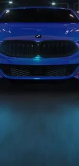 Sleek blue car with glowing lights on a nighttime road.