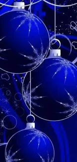 Blue Christmas ornaments with white patterns on a festive background.