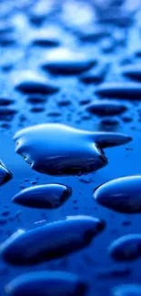 Close-up of glossy blue water droplets on a surface, creating a serene and fresh look.