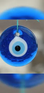 Blue evil eye charm wallpaper with a mystical design.