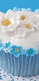 Blue cupcake with floral decorations on white doily