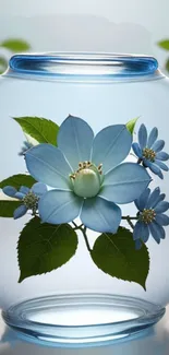 Elegant blue flower arrangement in a glass vase with green leaves.