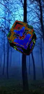 3D cube floats in a misty blue forest, creating a surreal digital art wallpaper.