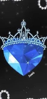 Blue heart gem with a crown on a black background.