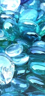 Close-up of shiny blue and aqua glass pebbles.