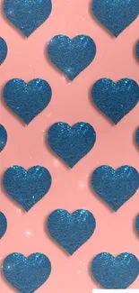 Blue glitter hearts on a pink backdrop in a repeating pattern.