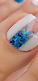 Close-up of blue glitter nail art, perfect for mobile wallpaper.