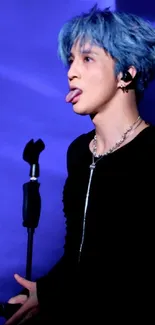 Performer with blue hair on stage in a captivating moment.