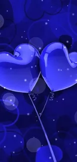 Blue heart-shaped balloons on a dark, dreamy background.