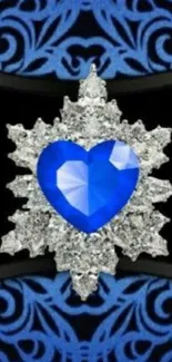 Heart-shaped blue sapphire jewel with silver pattern on phone wallpaper.