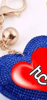 Blue heart keychain with red heart accent on a white background.