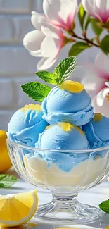 Blue ice cream with lemon and flowers in a glass bowl.