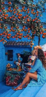 Woman on blue steps with oranges overhead.