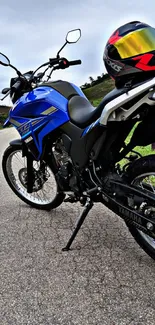 Blue motorcycle on a scenic road with helmet.