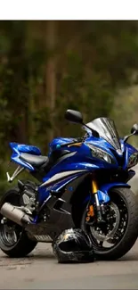 Sleek blue motorcycle on scenic road with helmet.