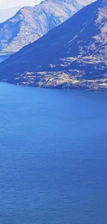 Majestic blue lake with mountain backdrop, perfect for nature lovers.