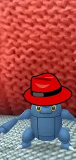 Wallpaper of a blue robot with a red hat against a knitted red background.