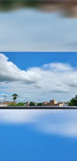 Sky blue cityscape wallpaper with clouds and trees.