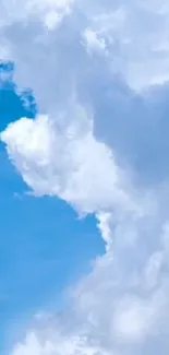 Fluffy white clouds against a bright blue sky.