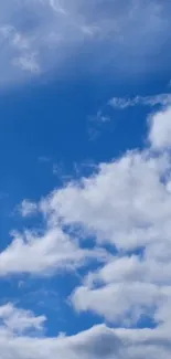 Clear blue sky with fluffy white clouds.