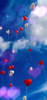 Heart-shaped balloons floating in a bright blue sky with clouds.