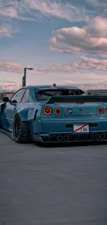 Blue Nissan Skyline R34 under a cloudy sky.