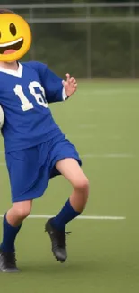 Young boy in blue soccer uniform on green field.