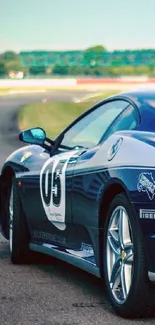 Blue sports car on a racetrack background.