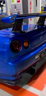 Blue Nissan sports car rear view in an indoor setting.