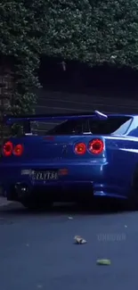 A sleek blue sports car parked with vibrant red taillights glowing.