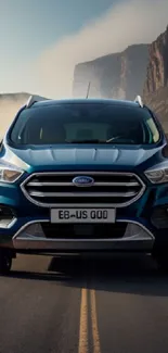 Blue SUV driving on a scenic road with mountain backdrop.