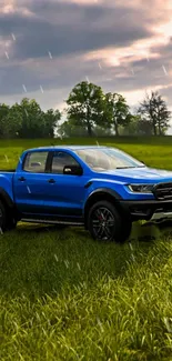 Blue truck in a green field with rain drops and cloudy sky.