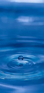 Blue water droplet creates ripples in a serene wallpaper.