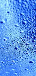 A bright blue textured surface with water droplets pattern.