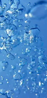 Close-up of blue water droplets floating freely in a serene sky blue background.