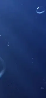 Serene wallpaper with blue water droplets on a dark background.