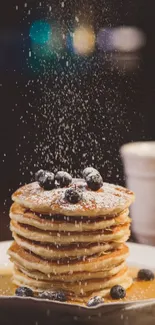 Stack of blueberry pancakes with coffee cup